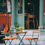 Cozy outdoor café with colorful chairs and rustic design. Ideal for travel and urban lifestyle imagery.